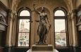 Lady Justice statue labeled “SCALES OF JUSTICE – DEDICATED 1954 –”