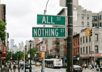 Street signs reading ALL ST and NOTHING ST at a busy city intersection
